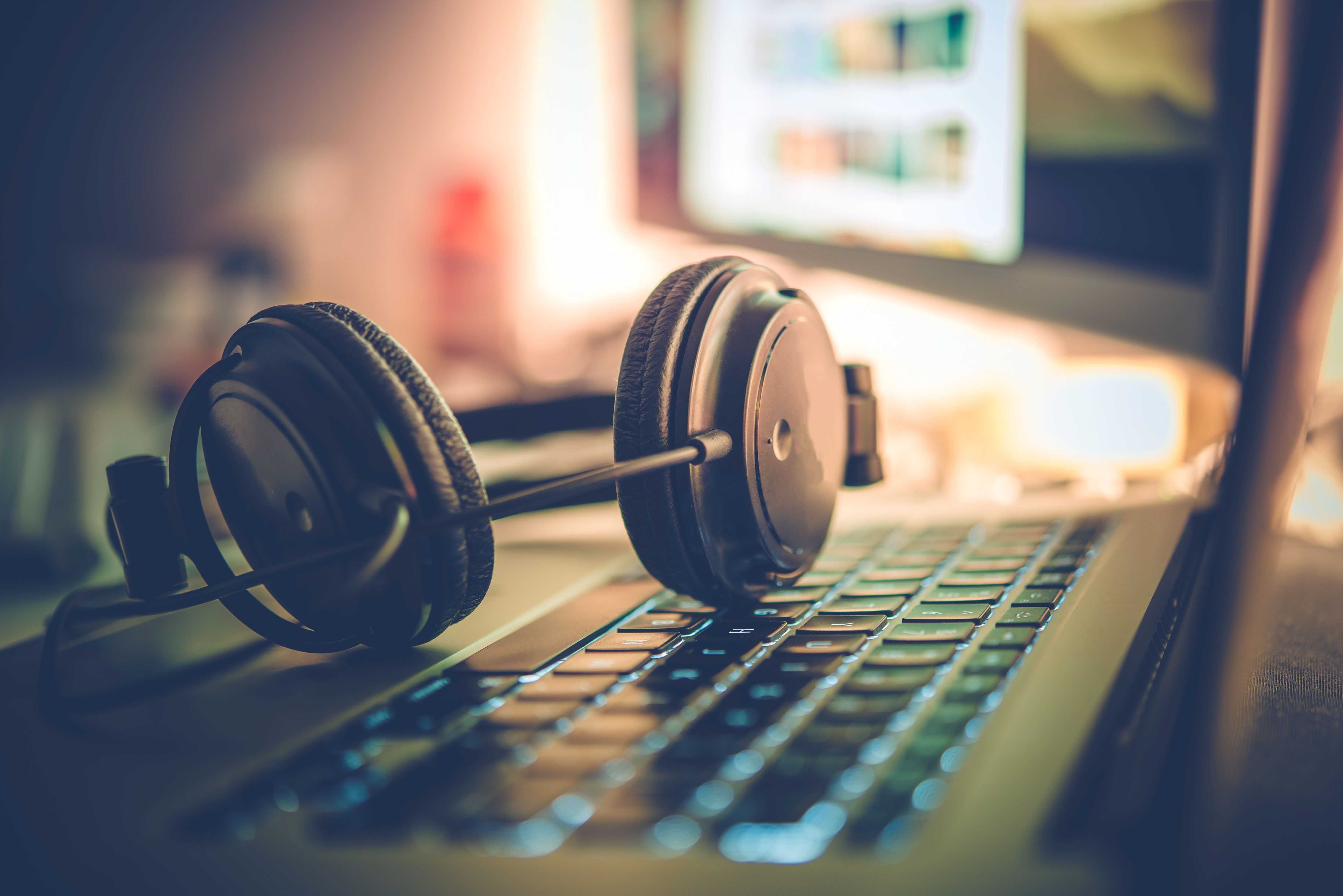 A picture of a headset on an opened laptop.